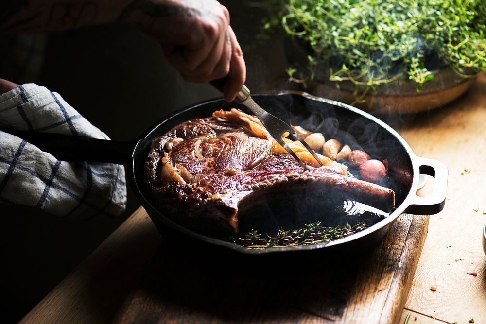 Chef cooking a steak in a pan food photography recipe idea