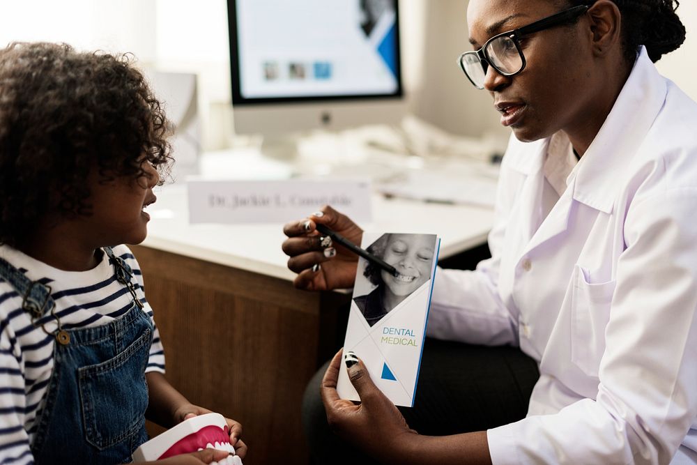 African kid having a conversation with a doctor