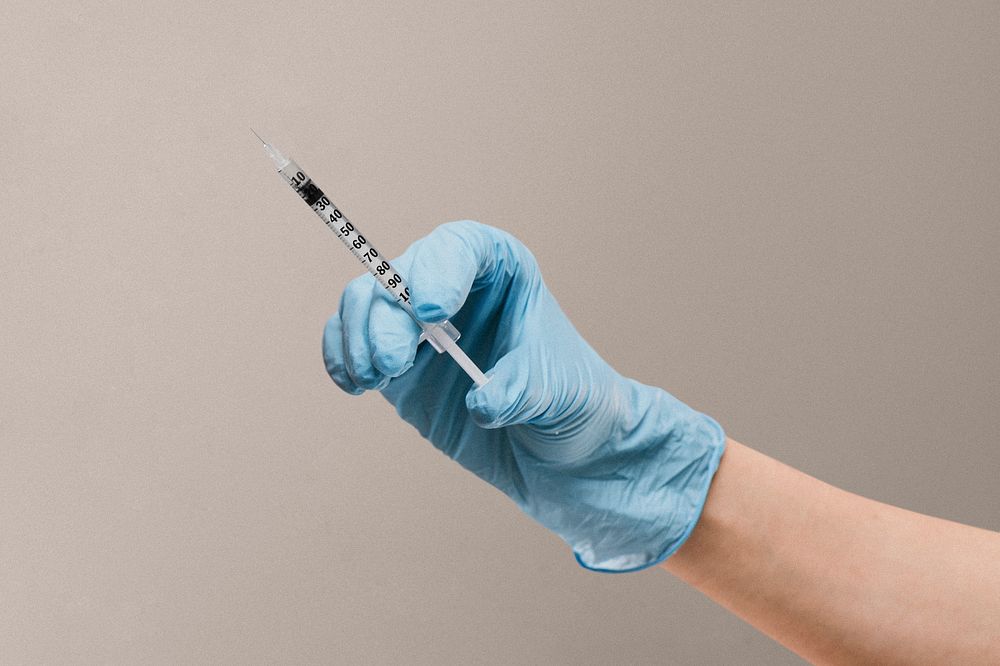 Nurse holding an injection syringe