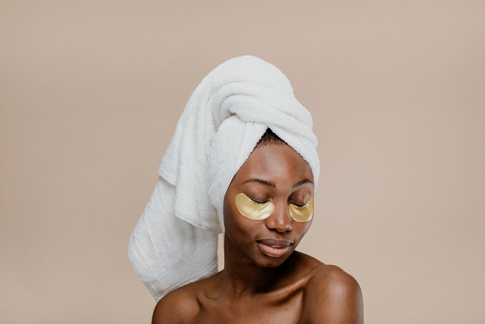 Black woman wearing a golden eye mask