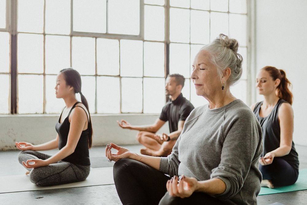 Diverse people meditating in a yoga class