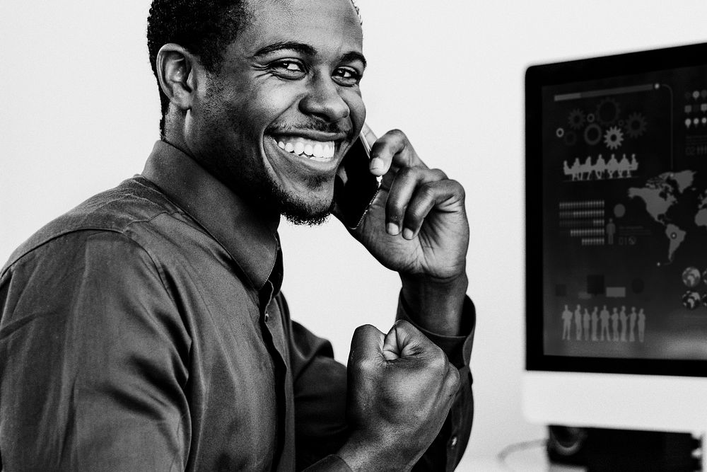 Happy black businessman talking on the phone