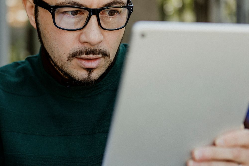 Stressful man using a tablet