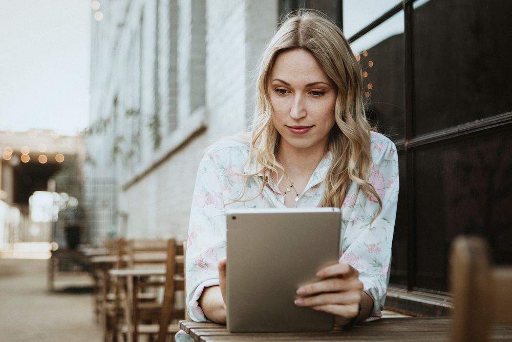 Woman using a digital tablet outdoors