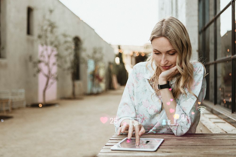 Happy woman using social media on a tablet