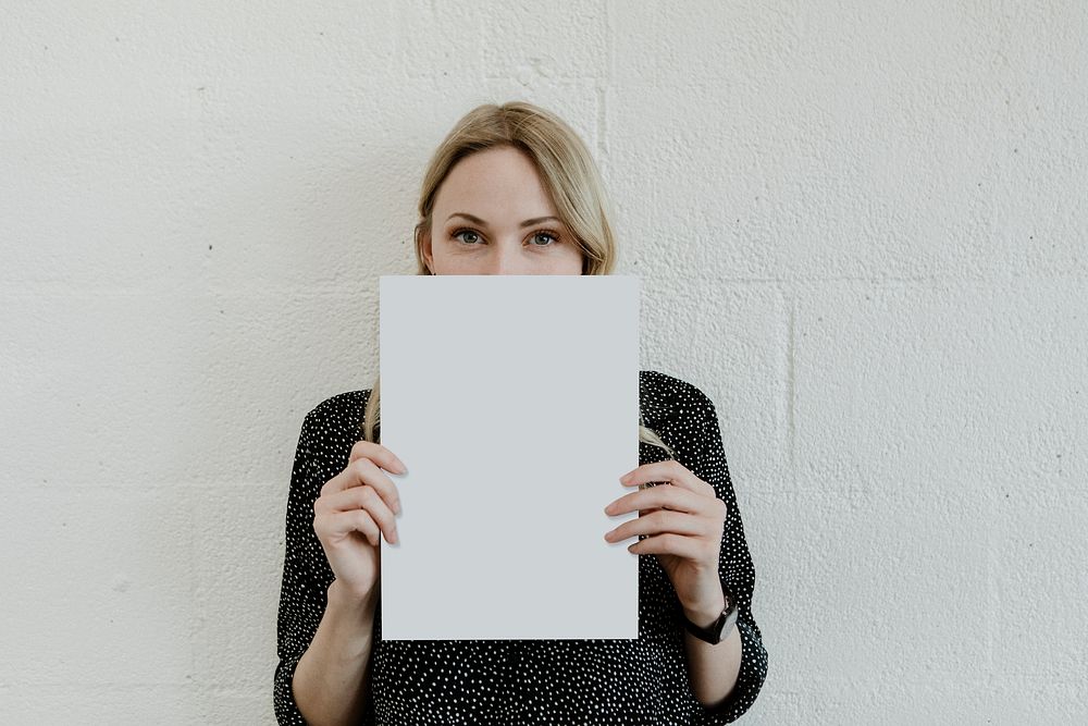 Blond woman showing a blank white poster