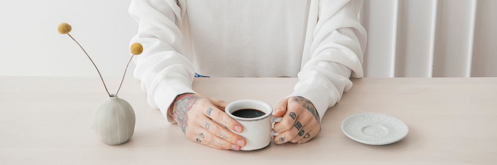 Smiling tattooed woman having a coffee