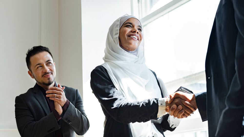 Muslim businesswoman shaking hands for a business agreement