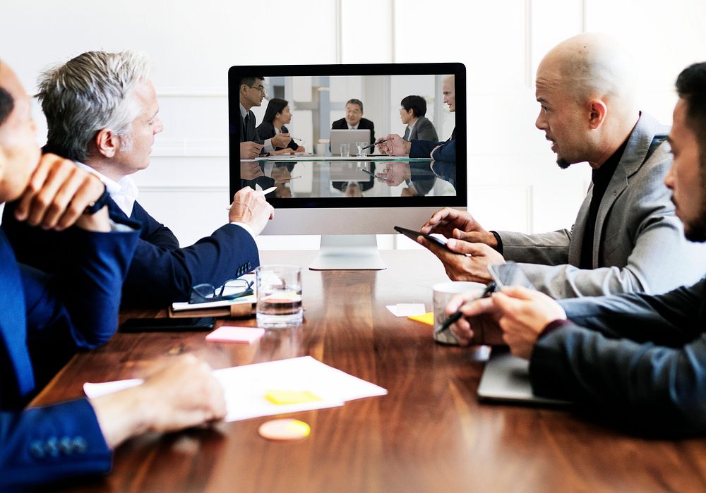 Business people having a conference meeting using a computer screen