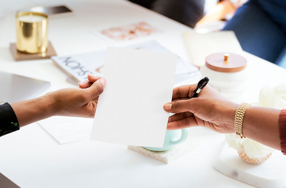 Woman handing a paper in the meeting room