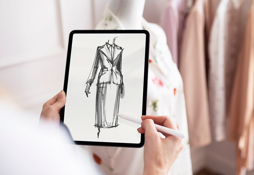 Fashion designer working on digital tablet