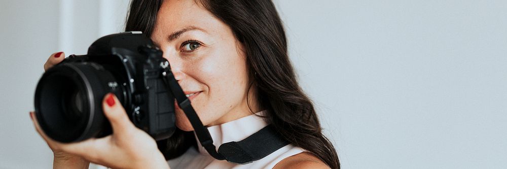 Female photographer holding digital camera