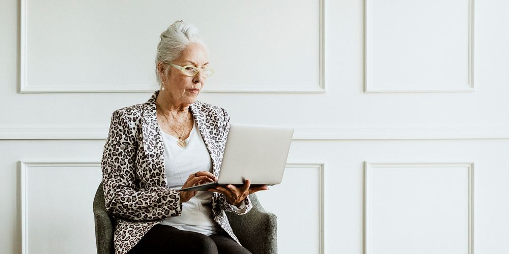 Empowering senior CEO using a laptop