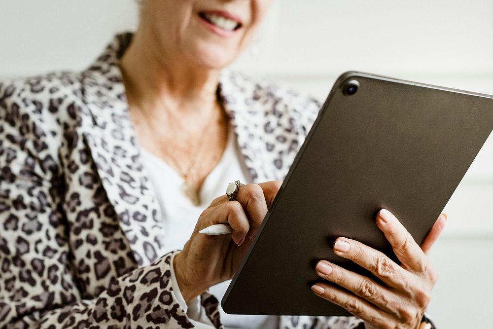 Elderly businesswoman using a digital tablet