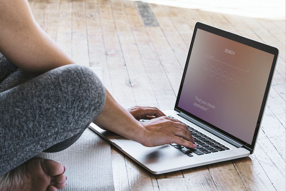 Yogini using a laptop on the floor