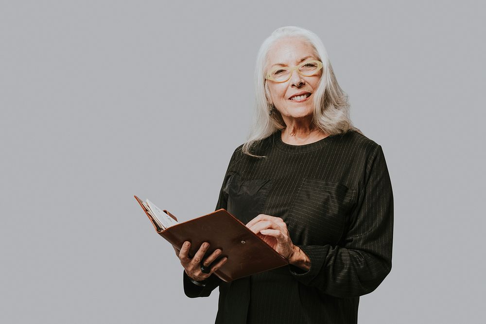 Senior businesswoman writing down on a notebook