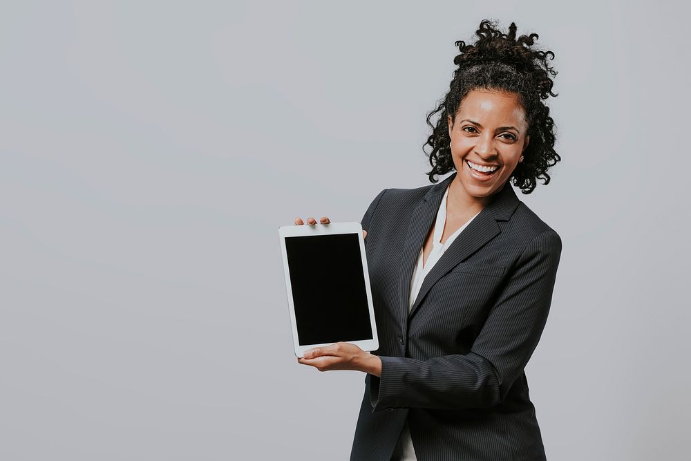 Happy businesswoman with a digital tablet