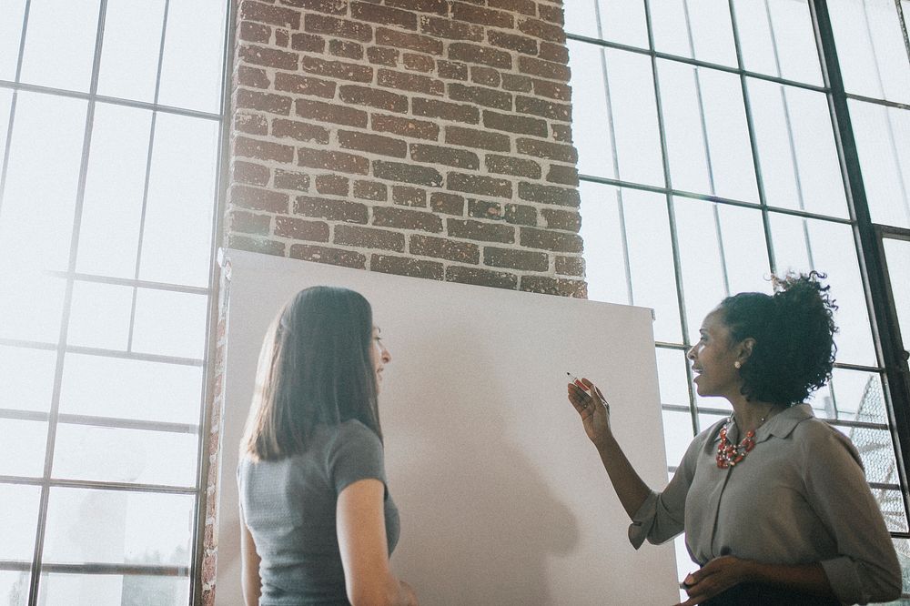 Two women discussing in a meeting