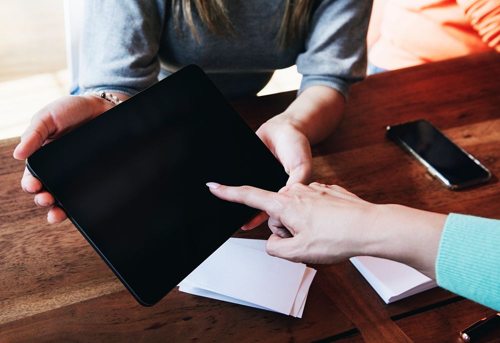 Woman pointing on a digital tablet screen