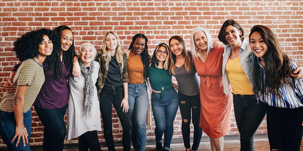 Diverse women standing together by a brick wall social banner 