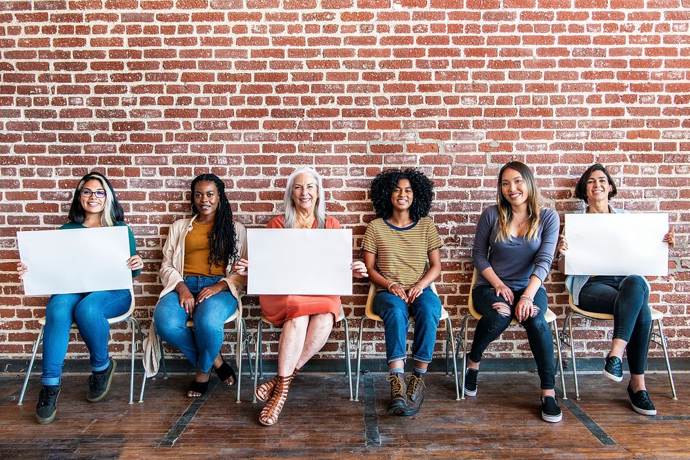 Diverse women showing blank posters template