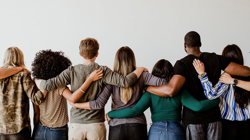 Rearview of diverse people hugging each other