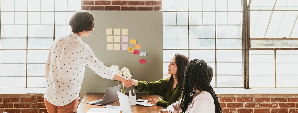 Happy businesswomen doing a handshake