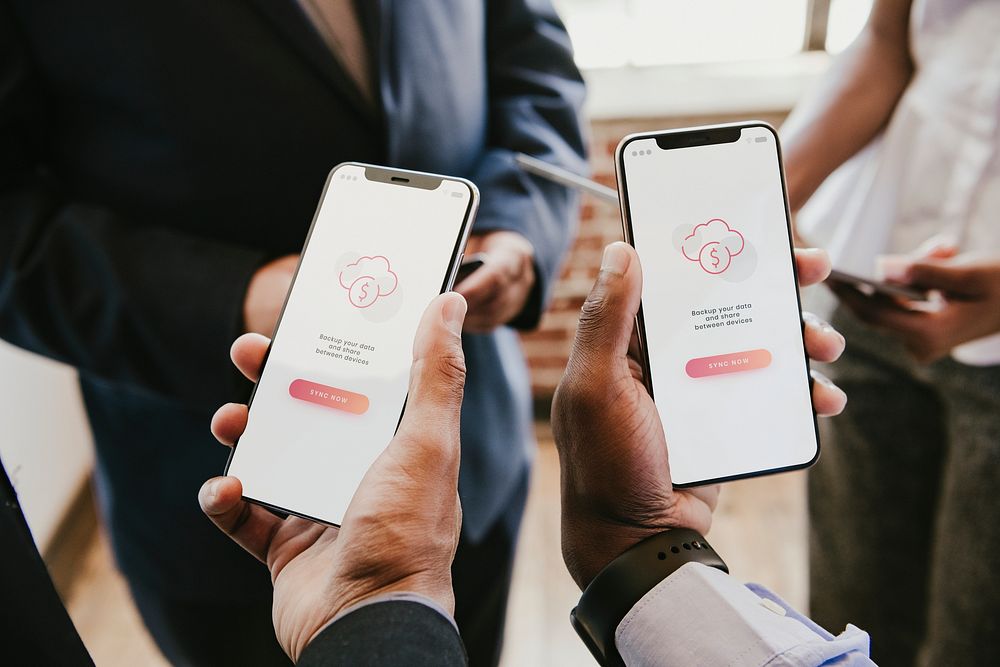 Businessmen syncing data from their phones