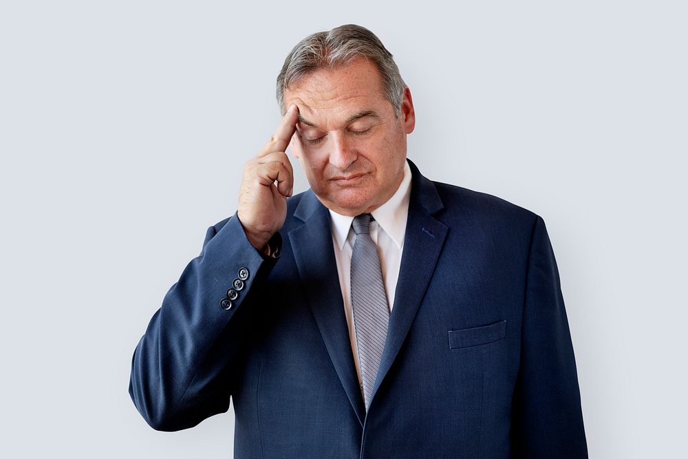 Stressed aged businessman touching his head