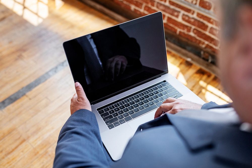 Businessman using a laptop with a screen design