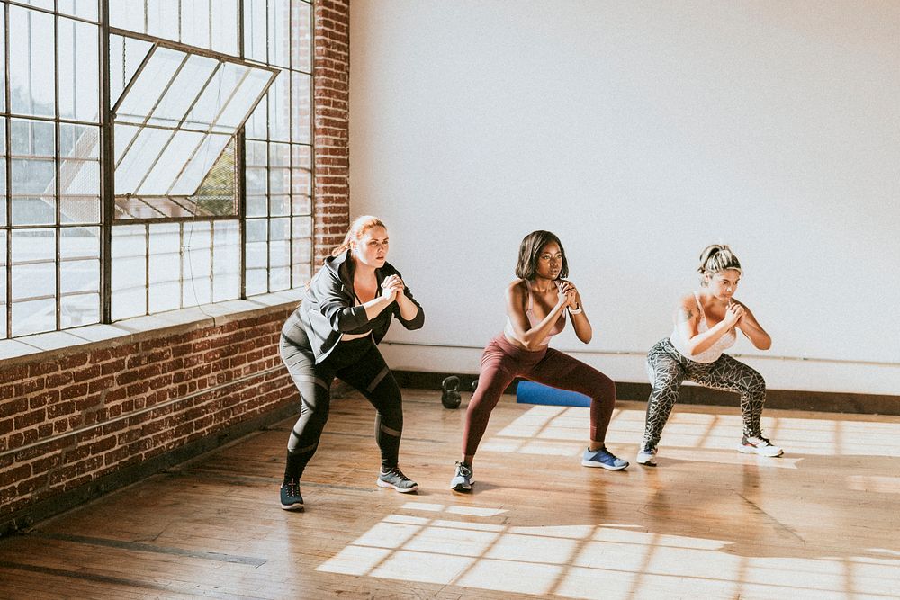 Diverse active women doing squats