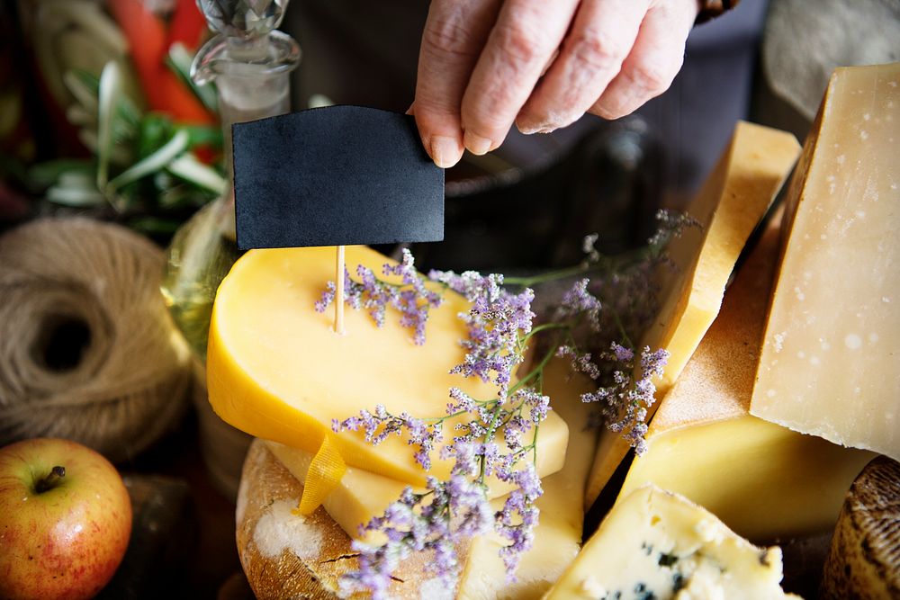 Stacked hard cheese in a beautiful spring setting and a label copy space for the cheese