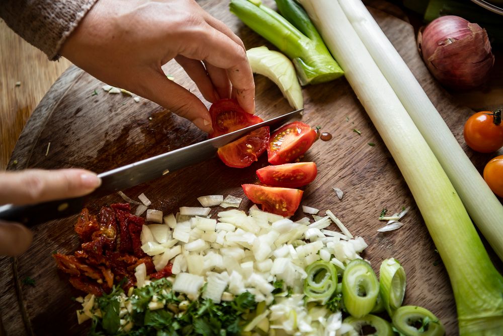 Woman cutting tomatoes on a cutting board