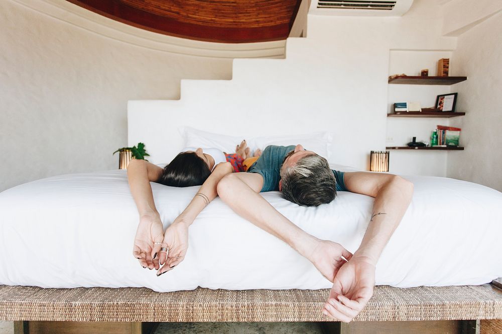 Honeymoon couple relaxing in a hotel room