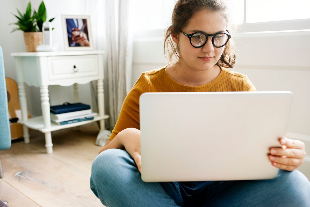 Teen girl chatting on her laptop