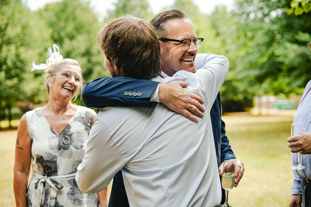 Fathers of the bride and groom hugging it out