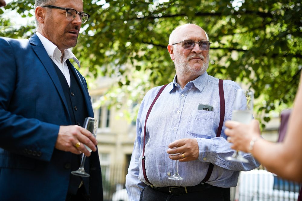 Old men having a discussion at a party