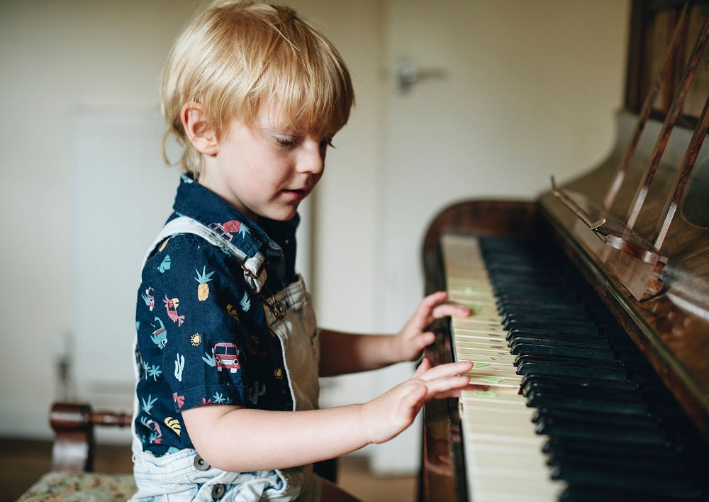 Young boy playing a piano