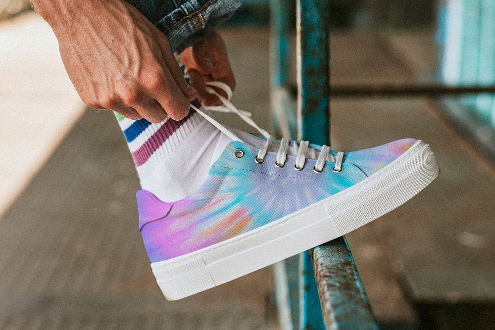 Man fixing shoelaces, tie dye Premium Photo rawpixel