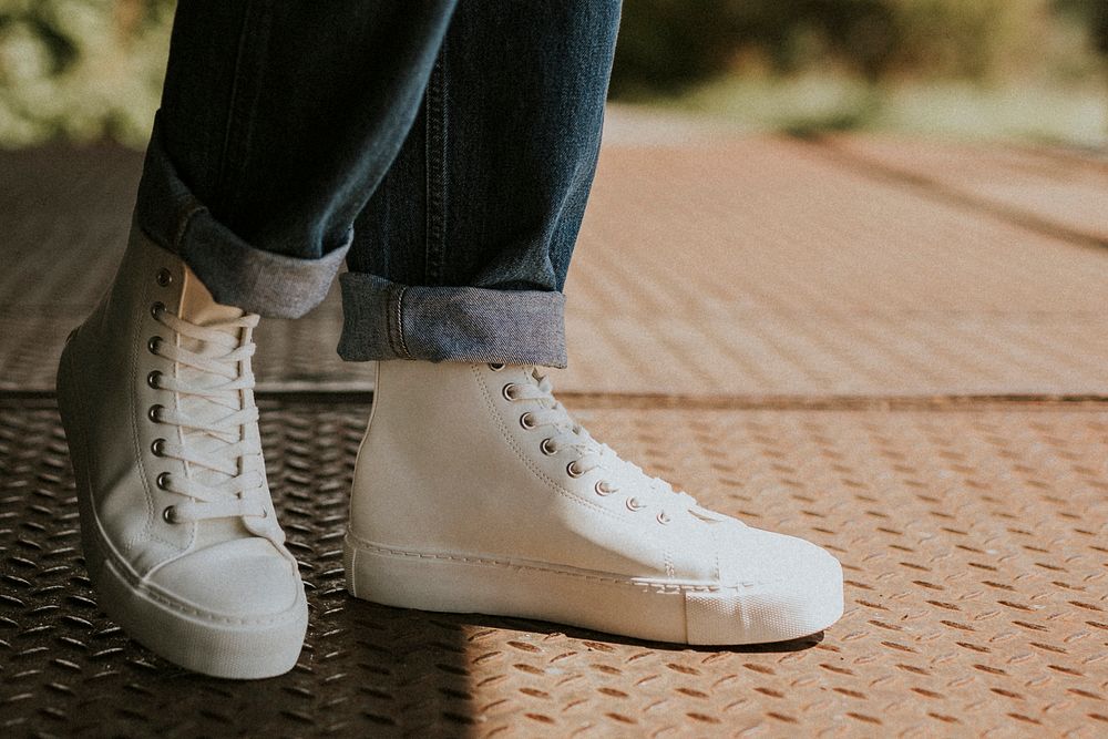 White high top sneakers on jeans model