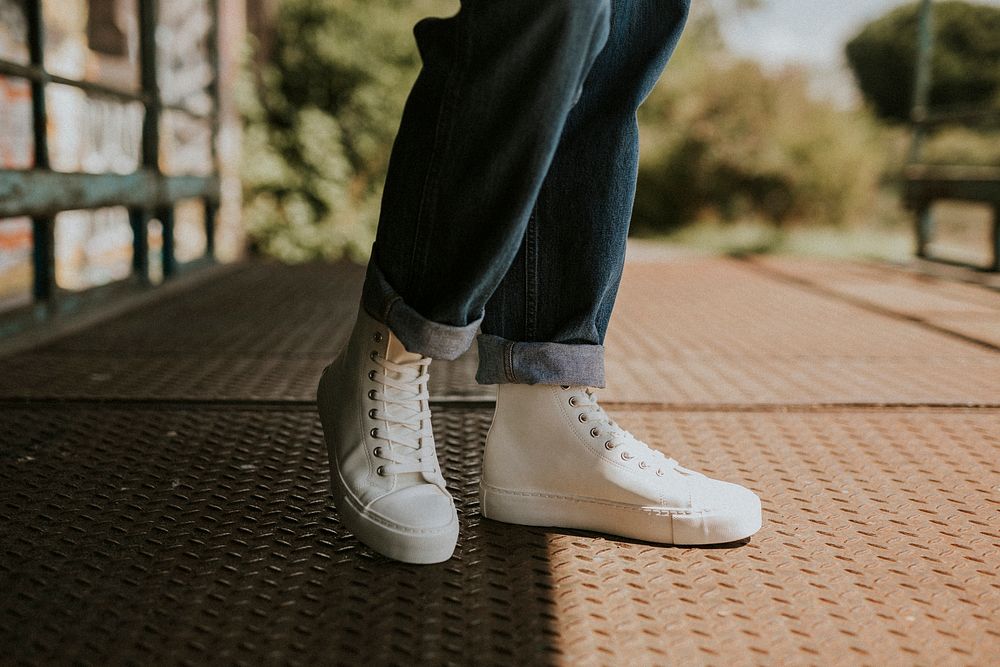 High top white sneakers on jeans model