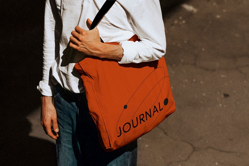 Man holding journal tote bag