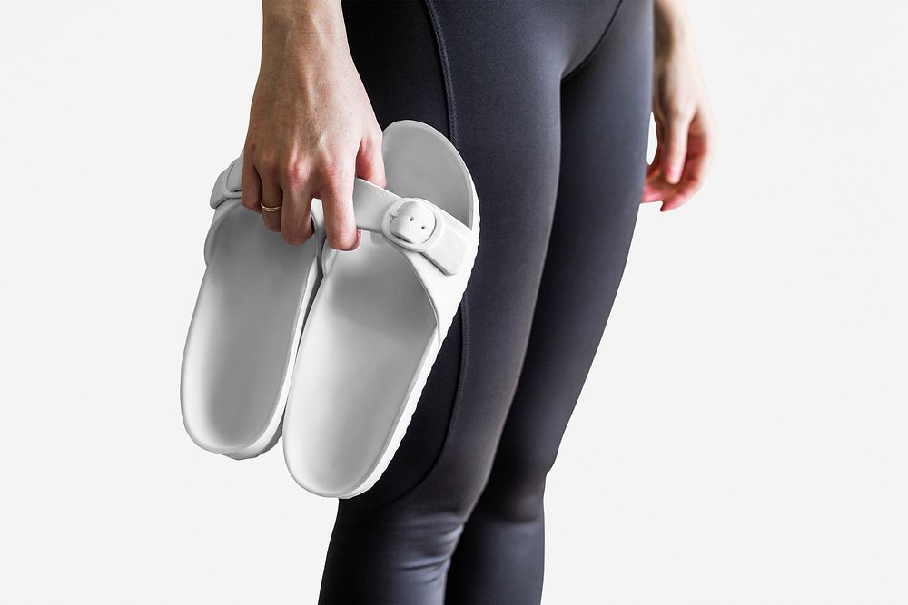 Model holding white sandals women's apparel mockup