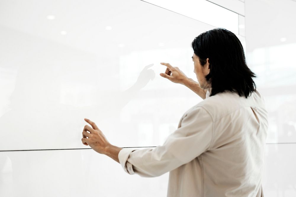 Professor presenting on a large white screen