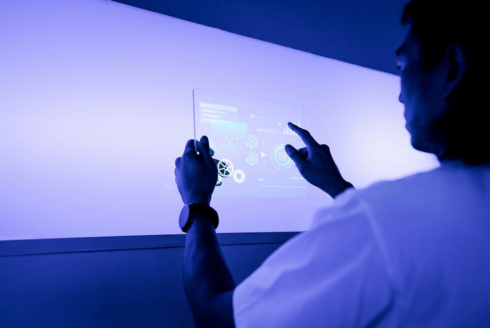 Designer using a transparent digital tablet screen futuristic technology