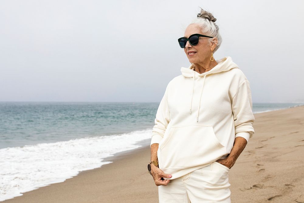 Senior woman relaxing at the beach in winter