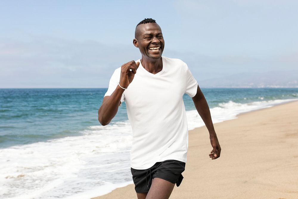 African American senior jogging at the beach