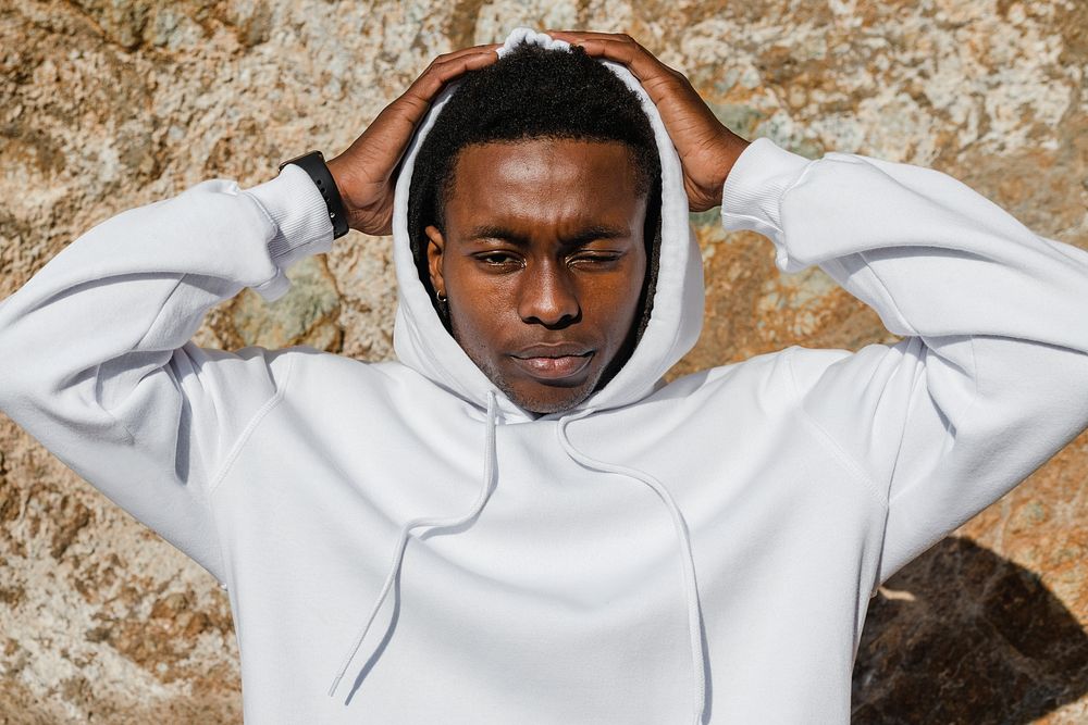 African American man in white hoodie posing outdoor photoshoot