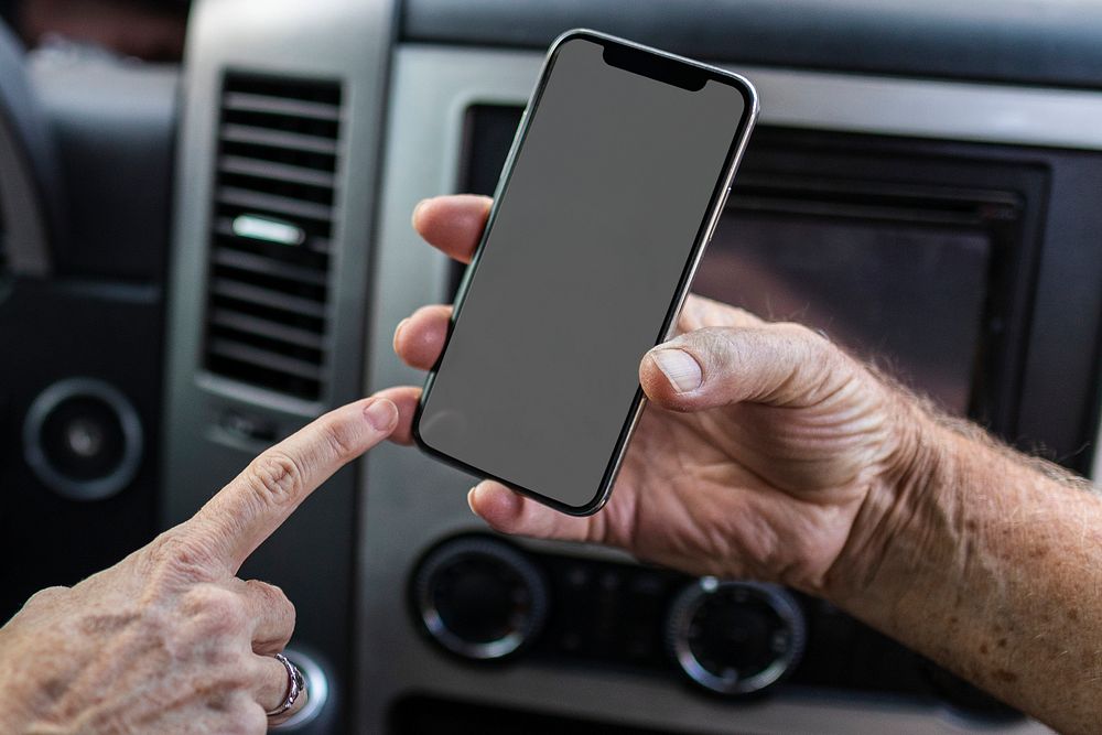 Smartphone black screen mockup psd with car console background