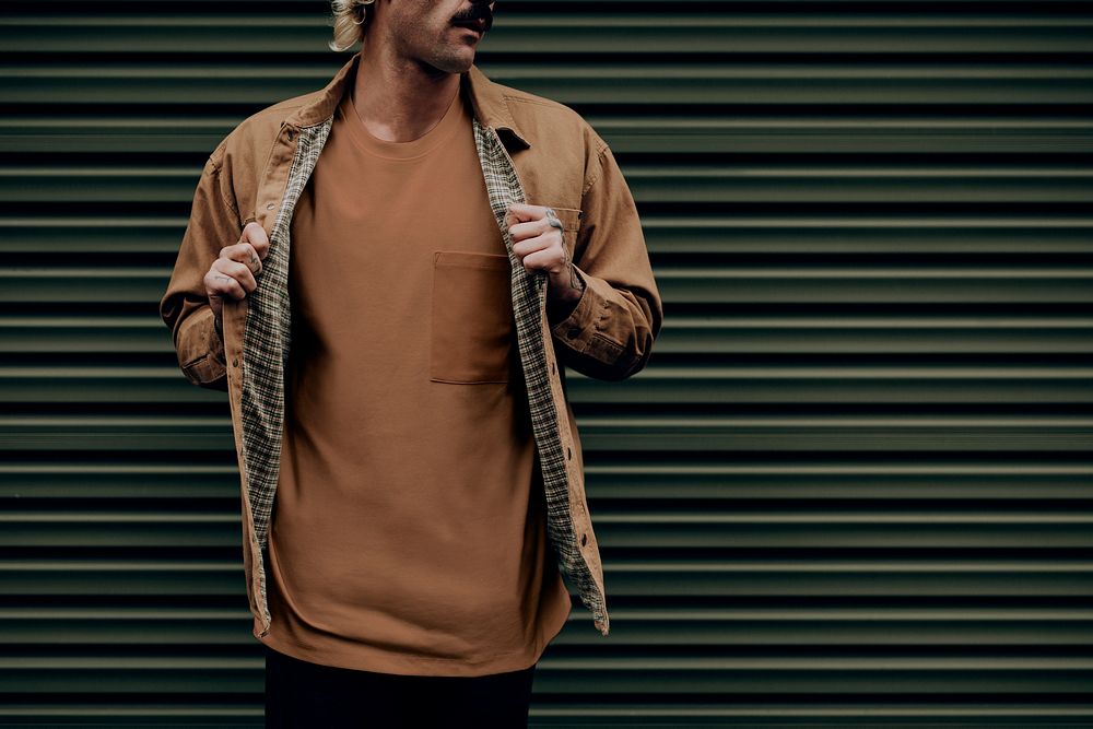 Blonde man in brown shirt jacket with design space 